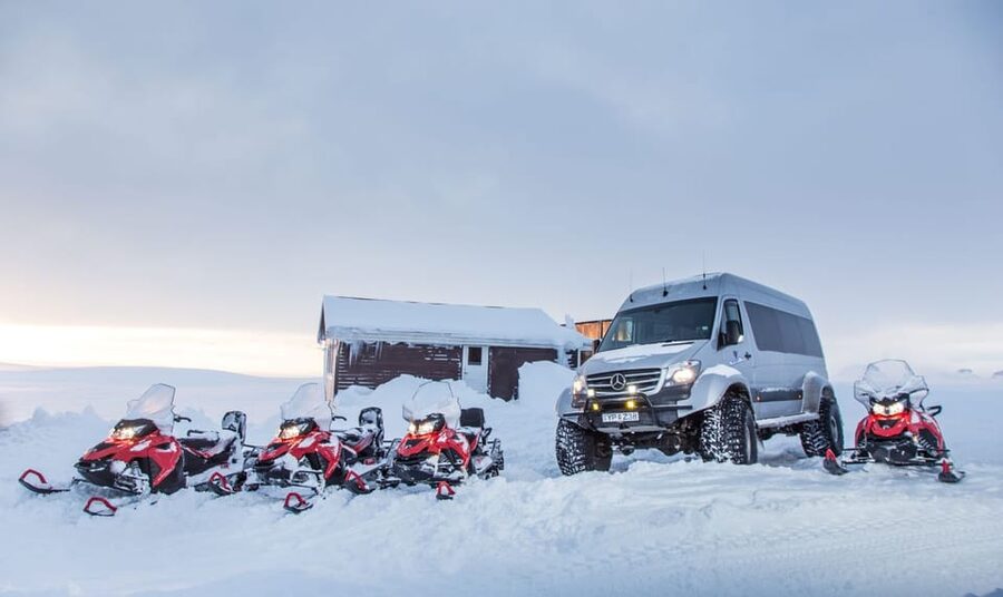 From Geysir: Snowmobiling & Ice Cave on Langjökull Glacier - The natural ice cave visit: blue light and volcanic ash stripes